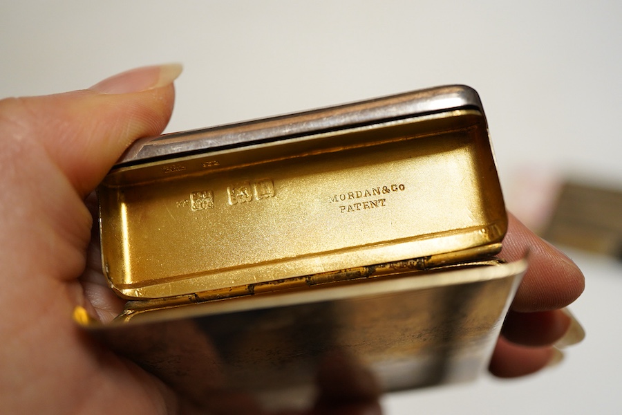 An Edwardian silver card case, London, 1903, Sampson Mordan & Co, plain rectangular form with sprung hinged cover, length 8.7cm., interior gilt together with a matchbox cover with linear engine turned decoration Birmingh